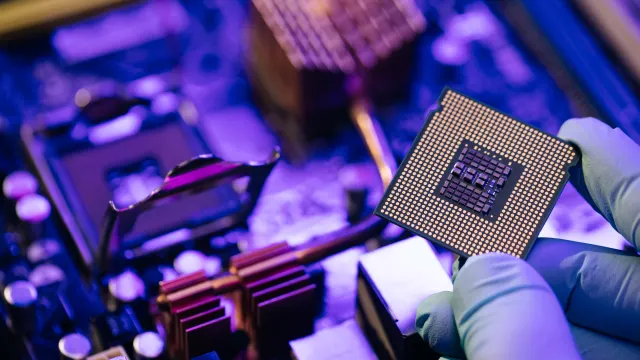 Jemand hält einen Mikrochip.